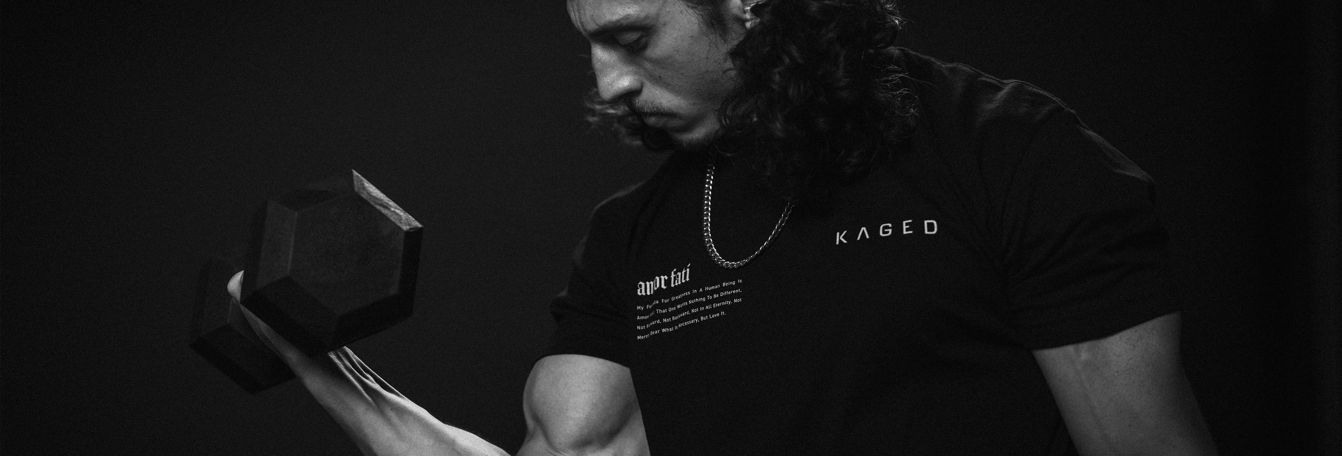 Athlete curling a heavy hex dumbbell in a dark studio, focused with flexed biceps