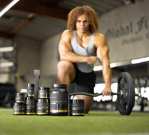 Kaged Athlete with Supplements in Foreground