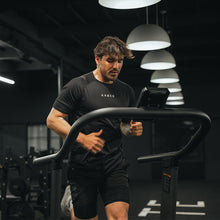 Male Kaged athlete running on a treadmill